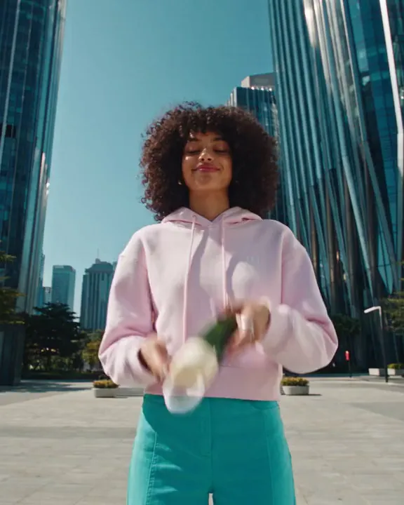A pink hoodie between Dubai towers
