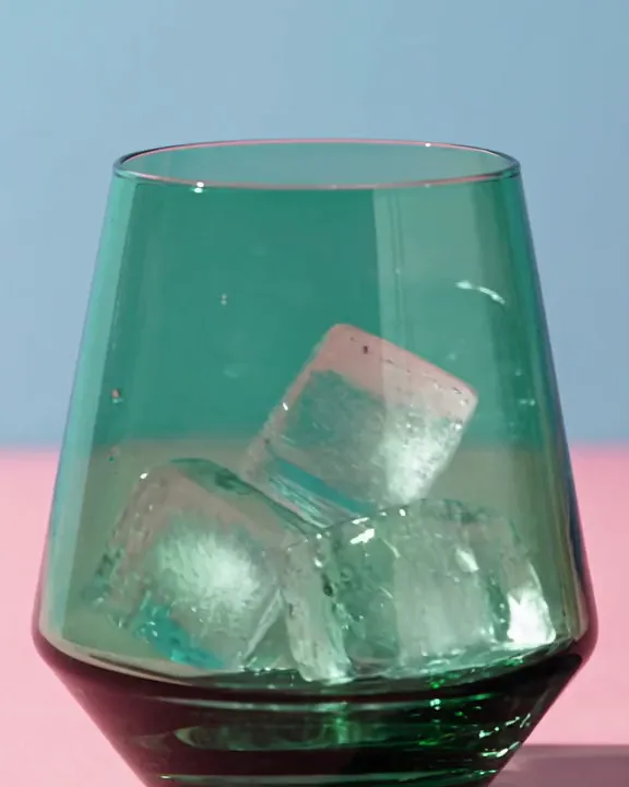 A greens powder poured over ice